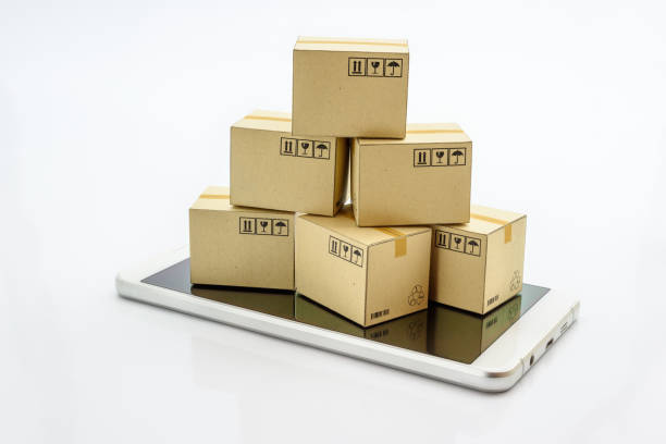 International freight service for online shopping or ecommmerce concept : Paper boxes with logos on a white smart mobile phone device. Consumers always shop goods or things online using the internet.