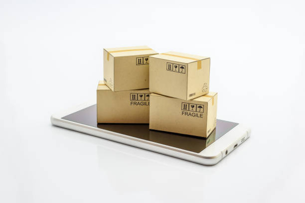 istock International freight service for online shopping or ecommmerce concept : Paper boxes with logos on a white smart mobile phone device. Consumers always shop goods or things online using the internet. 1028280846