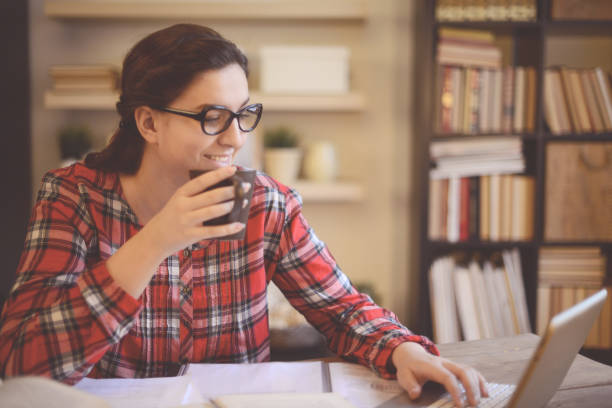 istock young woman working at home ( digital tablet and coffee) 1028285074