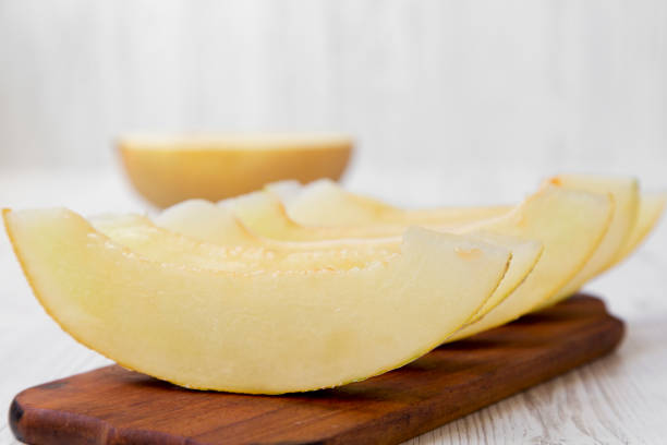 istock Sliced melon on rustic wooden board, side view. Close-up. 1028285362