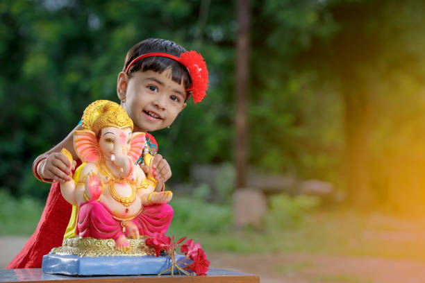 Little Indian girl child with lord ganesha and praying , Indian ganesh festival Little Indian girl child with lord ganesha and praying , Indian ganesh festival beautiful traditional indian girl stock pictures, royalty-free photos & images