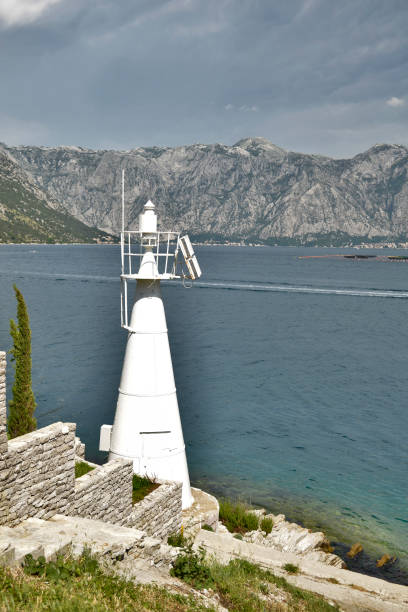 istock White lighthouse on the promontory in the bay 1028289900