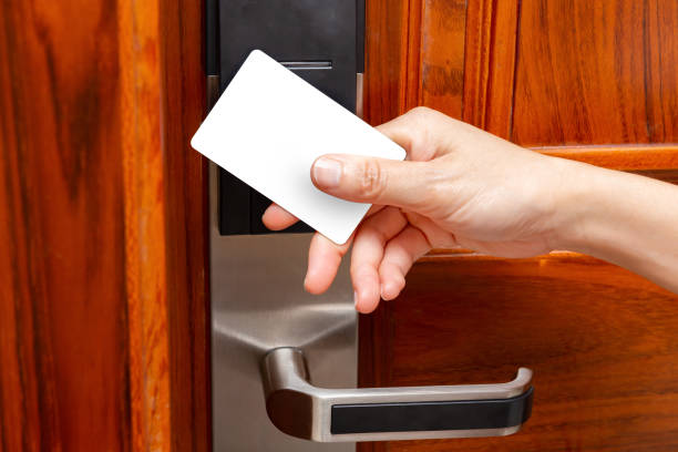 istock lady opening an electronic door lock by a blank security card 1028291968