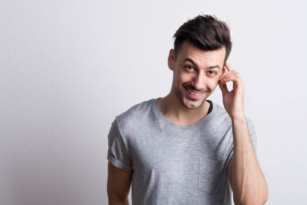 istock Portrait of a young cheerful man in a studio. Copy space. 1028298086
