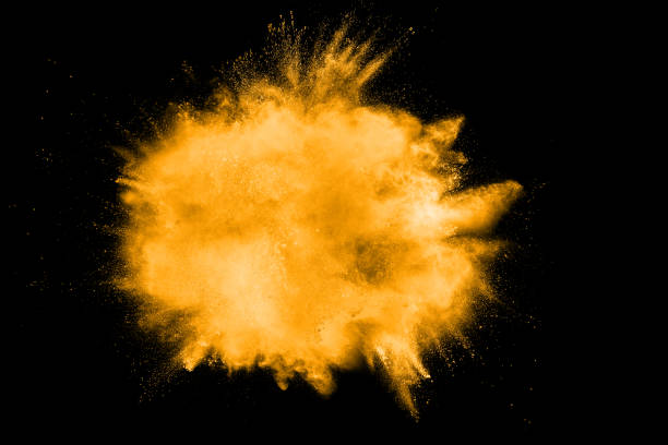 istock abstract orange dust explosion on  black background. abstract orange powder splattered on black background, Freeze motion of orange powder splash. 1028305634