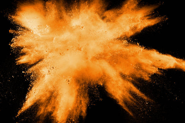istock abstract orange dust explosion on  black background. abstract orange powder splattered on black background, Freeze motion of orange powder splash. 1028305652
