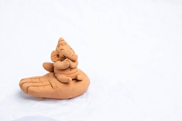 istock Handmade cute red clay elephant on hand sculpture 1028305760