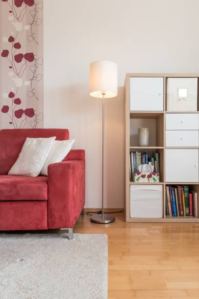 istock Vertical. Living room with sofa, lamp and library 1028310032