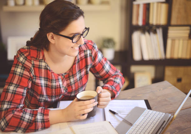 istock young woman working at home ( digital tablet and coffee) 1028312594