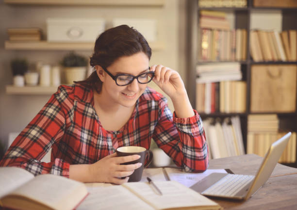 istock young woman working at home ( digital tablet and coffee) 1028315704
