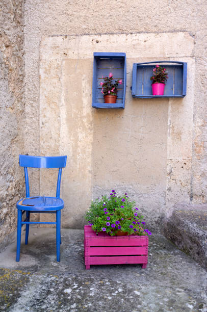 istock Italy: Coloured flowers vase on wall 1028327884
