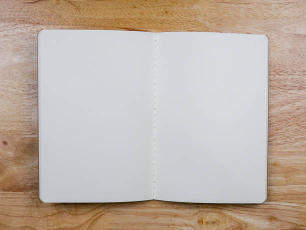 istock Recycled paper book on wooden background 1028333050