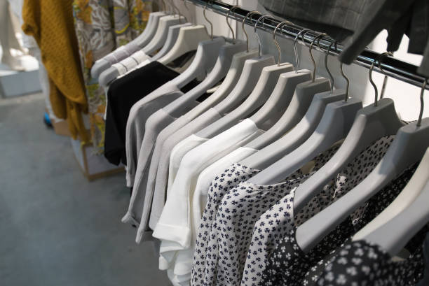 istock Clothes hang on a shelf in store 1028334632