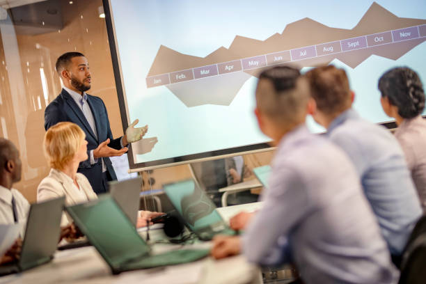 istock African-American financial advisor giving forecast to board members 1028343616