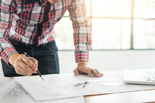 istock Midsection Of Engineer Making Blueprint In Office 1028351500