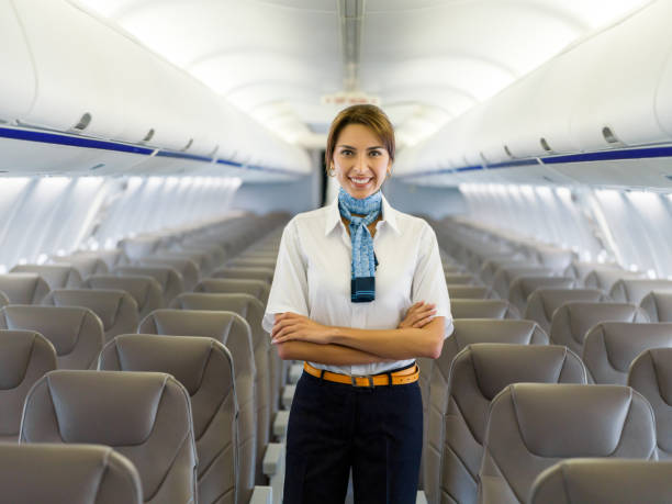 istock Portrait of a beautiful flight attendant in an empty airplane 1028360480