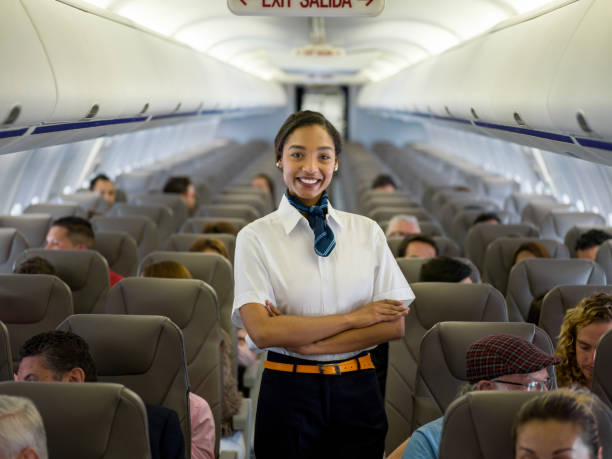istock Beautiful African American flight attendant in an airplane 1028360532