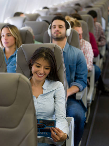 istock Happy woman traveling by plane 1028360574