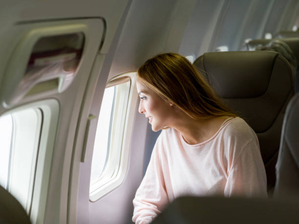 istock Beautiful woman traveling by plane 1028360612
