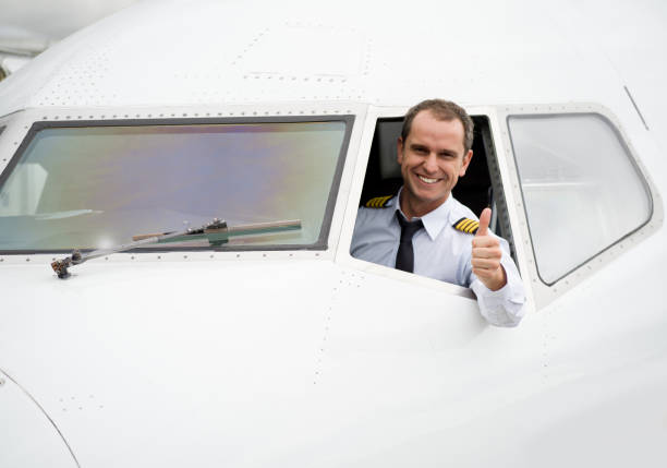 portrait of a happy pilot in the airplane with thumbs up - airplane cockpit taking off pilot imagens e fotografias de stock