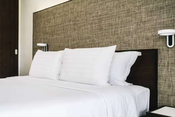 istock White Bed With Pillows In Bedroom 1028360714