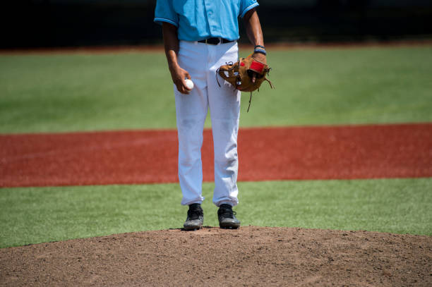 istock Low Section Of Baseball Player Standing On Playing Field During Sunny Day 1028368526