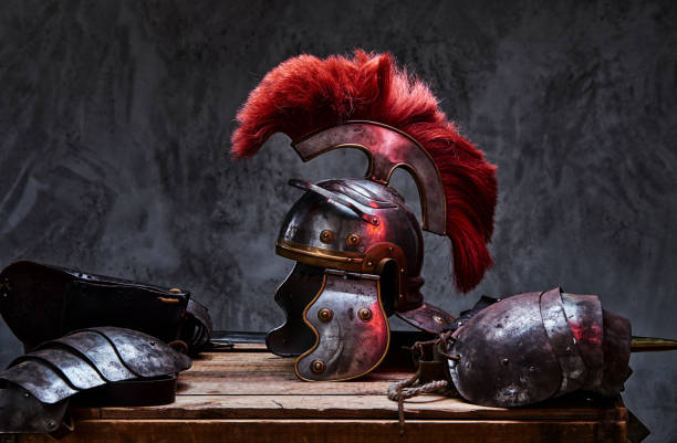 Complete combat equipment of the ancient Greek warrior lie on a box of wooden boards. Complete combat equipment of the ancient Greek warrior lie on a box of wooden boards. Isolated on a dark background. sword photos stock pictures, royalty-free photos & images