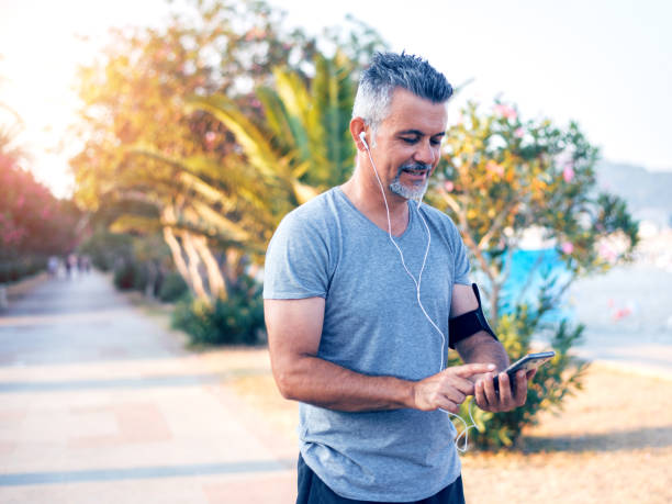 istock Man Preparing His Music Before Running 1028369166