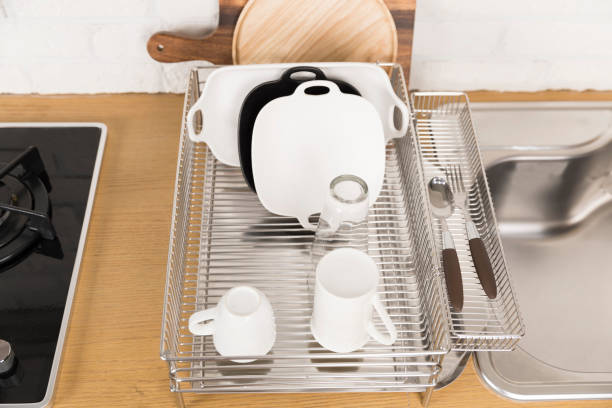 istock Kitchen with various kitchen tools, background with kitchen racks and plants. The appearance of drying dishes and bowls. 1028370014
