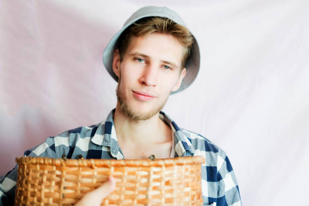 istock young man holding collected harvest with basket isolated 1028372438