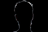 lighten portrait silhouette of a human head in the dark  background