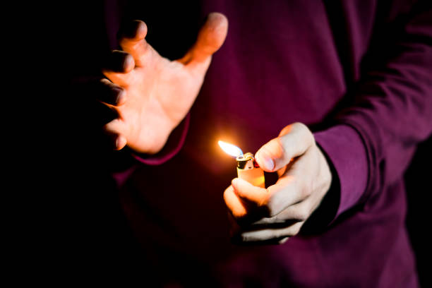 istock close up hands holding gas lighter in the dark 1028373734