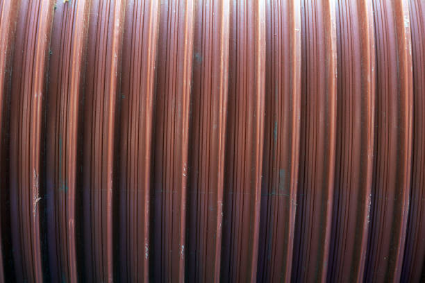 istock Close-up image of a red metallic profile pattern. Metal ribbed surface. 1028379970