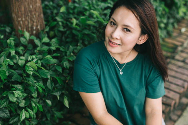 istock Woman sitting in park 1028390622