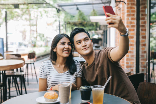 istock Young couple taking a selfie 1028390830