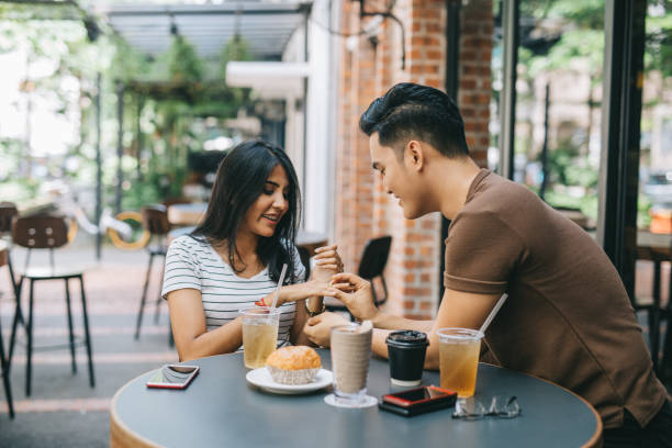 Man giving engagement ring to girlfriend