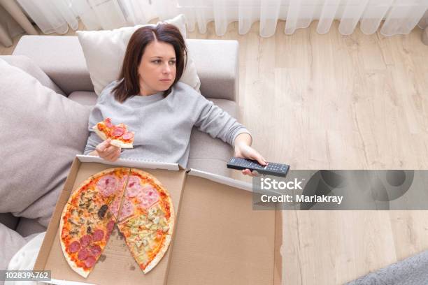 Woman Eating Pizza Image Taken From Above Stock Photo - Download Image Now - Eating, Couch Potato, Sofa