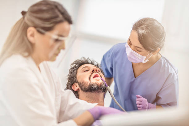 istock Female dentist and male patient 1028397064
