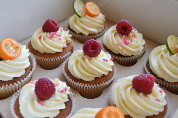 istock Vanilla cupcakes with fruits on top. 1028397314
