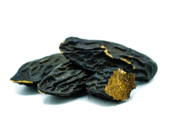 istock Three whole tonka beans and one cut open isolated on white background 1028397332