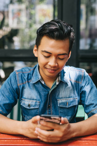 istock Young man sitting in cafe 1028398128