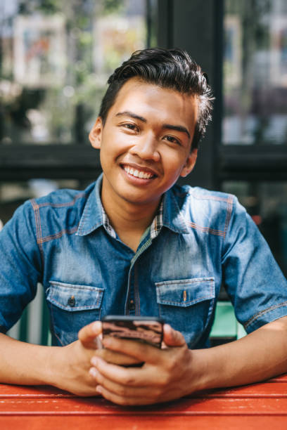 istock Young man sitting in cafe 1028398132