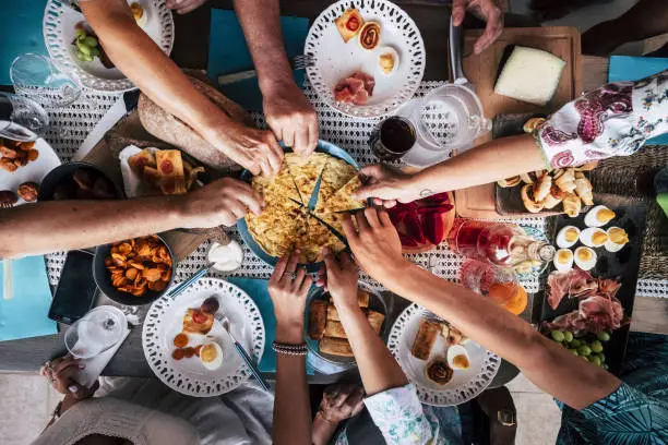 Photo of Food Catering Cuisine Culinary Gourmet Party Cheers Concept friendship and dinner together. mobile phones on the table, pattern and background colorful image with people eating and taking food during an event