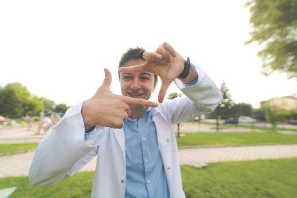 Doctor is finger framing with his hands