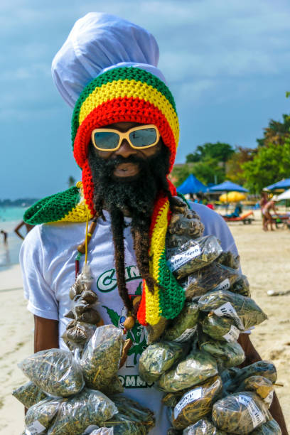 Jamaican Rastafarian man Negril, Jamaica - July 13 2014: Jamaican Rastafarian man selling herbs on the beach in Negril. hair band stock pictures, royalty-free photos & images