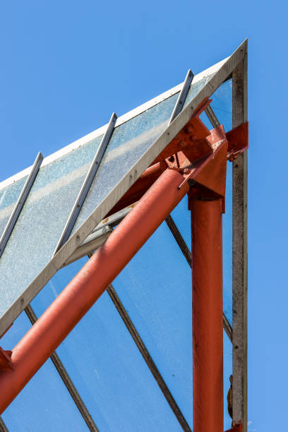 istock Abstract achitecture. Modern design apex with red tubing against blue sky. 1028410954