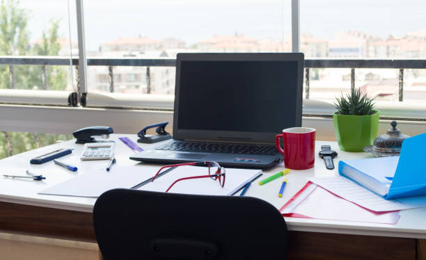 Messy office desk against city view Messy office desk against city view paper clip office supply stack heap stock pictures, royalty-free photos & images