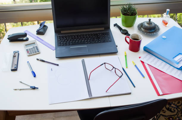 Top view of messy office desk Top view of messy office desk paper clip office supply stack heap stock pictures, royalty-free photos & images