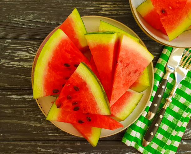 istock watermelon slices on a black wooden background 1028417946