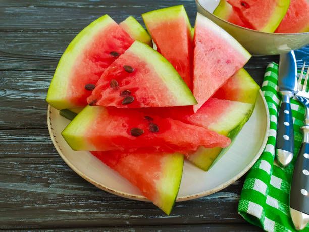 istock watermelon slices on a black wooden background 1028418318